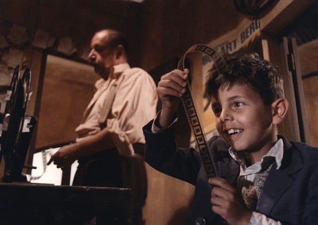 Cinema Paradiso: Salvatore looks at film negatives in the projector