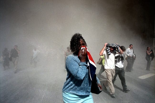 USA. NYC. 9/11/2001. People use masks made out of clothing to protect themselves from dust that is thick in the air after the collapse of the World Trade Center towers © Gilles Peress/Magnum Photo