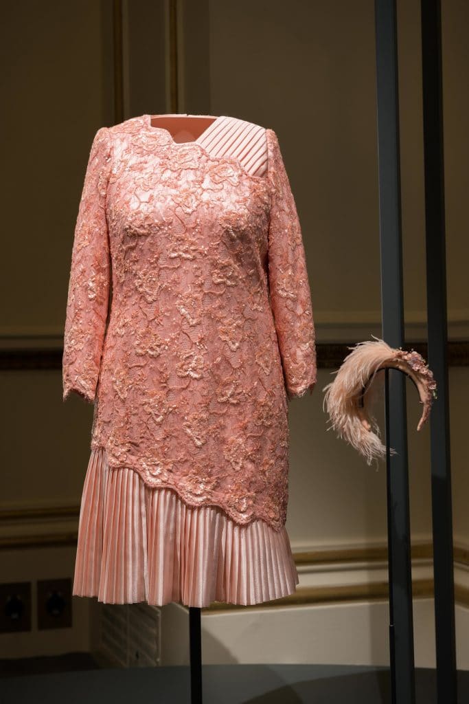 EMBARGOED UNTIL 00:01 BST FRIDAY, 22 JULY 2016 Crystal and lace peach beaded cocktail dress by Angela Kelly. The dress and headpiece were worn by The Queen when she appeared in the opening ceremony of the London 2012 Olympics with James Bond. Images for use only in connection with the exhibition Fashioning a Reign: 90 Years of Style from The Queen's Wardrobe at the Summer Opening of Buckingham Palace, 23 July - 2 October 2016. Images must not be archived or sold-on. Royal Collection Trust / √É¬Ç√Ç¬© Her Majesty Queen Elizabeth II 2016. Single use only; not to be archived or passed on to third parties.