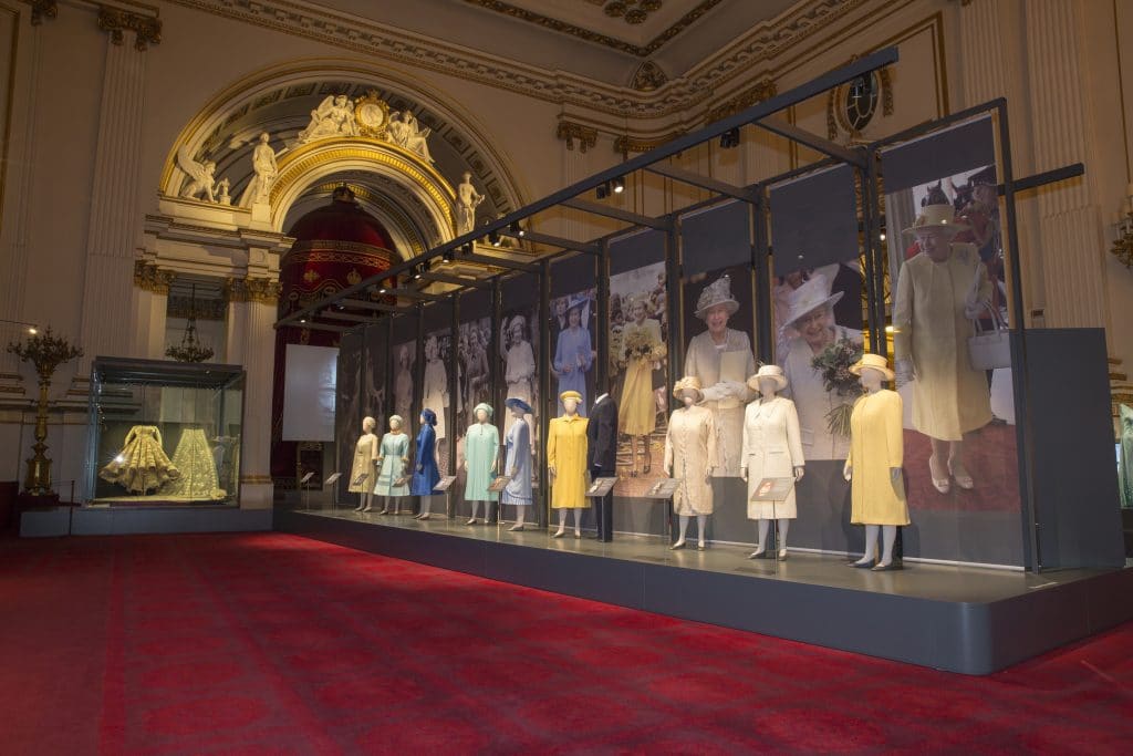 A display of dresses on show at Fashioning a Reign: 90 Years of Style from The Queen's Wardrobe at the Summer Opening of Buckingham Palace, including Her Majesty's wedding dress by Sir Norman Hartnell, 1947 (far left) Images for use only in connection with the exhibition Fashioning a Reign: 90 Years of Style from The Queen's Wardrobe at the Summer Opening of Buckingham Palace, 23 July - 2 October 2016. Images must not be archived or sold-on. Royal Collection Trust / Â© Her Majesty Queen Elizabeth II 2016. Single use only; not to be archived or passed on to third parties.